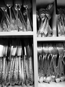 a shelf filled with lots of silver spoons and forks at Boutique Hotel Dorer in Schönwald