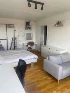 a bedroom with a bed and a couch and a desk at Studio apartment in Copenhagen. in Copenhagen