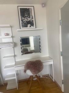a white desk with a chair and a mirror at Studio apartment in Copenhagen. in Copenhagen