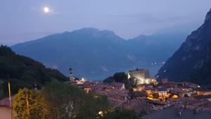 a view of a town in the mountains at night at Villa sogno Garda lake in Tenno