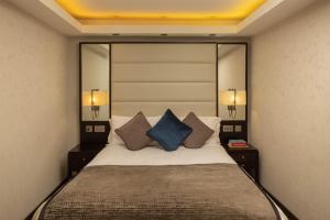 a bedroom with a large bed with two night stands at Montcalm Brewery Townhouse in London