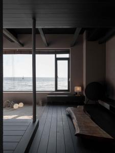a living room with a view of the ocean at Banwol Poolvilla in Busan