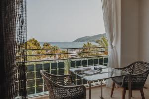 a room with a table and chairs and a large window at Aguas de Ibiza Grand Luxe Hotel - Small Luxury Hotel of the World in Santa Eularia des Riu