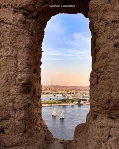 two sailboats on a river seen through a window at Salah El Din Restaurant on the Nile Corniche in Aswan