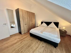 Ένα ή περισσότερα κρεβάτια σε δωμάτιο στο Braviscasa Stadthaus Kaiserstuhl Endingen