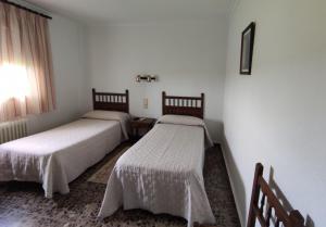 Postel nebo postele na pokoji v ubytování Hostal El Molino