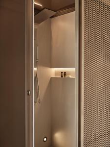 a bathroom with a shower with a glass door at Domus Blanc Boutique Hotel in Chania Town