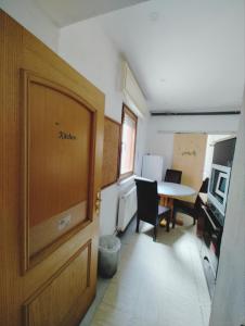 a room with a table and a door and a table and chairs at The ARK Eco Homestay in Esch-sur-Alzette