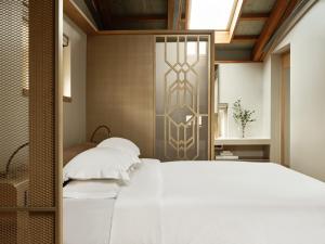 Postel nebo postele na pokoji v ubytování Domus Blanc Boutique Hotel