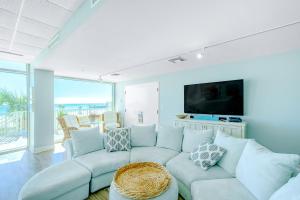 a living room with a couch and a tv at Sea Breeze 311 Deluxe in Biloxi