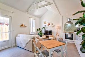 uma sala de estar com um sofá e uma mesa em L'Air Marin - Calm & cosy house by the sea em Ouistreham