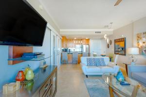 a living room with a large flat screen tv at Ocean Club 1607 in Biloxi