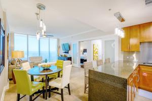 a kitchen and living room with a table and chairs at Ocean Club 1607 in Biloxi