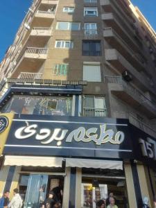 a store sign in front of a tall building at Amazing Sea View 2 bedroom apartment in Alexandria
