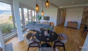 Una sala de estar con una mesa y sillas y un sofá. en Apartment Vista Neretva, en Mostar