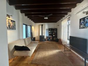 a living room with a couch and a ceiling fan at Olive House in Kyrenia