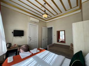 um quarto de hotel com uma cama e uma televisão em Le Safran Suite Hotel em Istambul