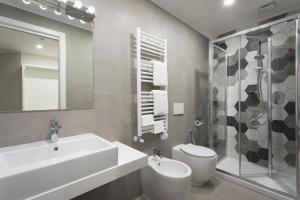 a bathroom with a sink and a toilet and a shower at Noba Hotel e Residenze in Rome