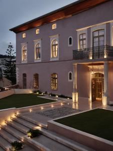 a large house with lights in the yard at Domus Blanc Boutique Hotel in Chania