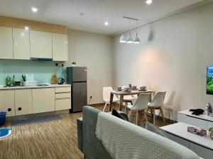 a kitchen and living room with a couch and a table at Setapak Cozy 4-6 Pax Suite ZetaPark by CITYSPACE in Kuala Lumpur
