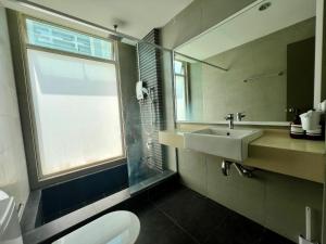 a bathroom with a sink and a toilet and a window at Setapak Cozy 4-6 Pax Suite ZetaPark by CITYSPACE in Kuala Lumpur