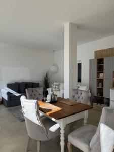 a living room with a wooden table and chairs at Sievershof Hofblick in Wietzendorf