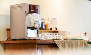 a coffee machine sitting on top of a counter at ARIBĖ Hotel Klaipėda, Free Parking in Klaipėda