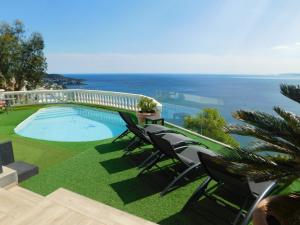 a swimming pool with chairs and a view of the ocean at GMID IMMO A228 Casa Unica in Roses