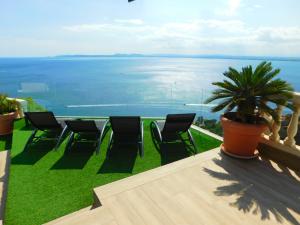 a balcony with chairs and a view of the ocean at GMID IMMO A228 Casa Unica in Roses