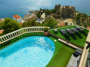 a swimming pool on a house with a view of a castle at GMID IMMO A228 Casa Unica in Roses