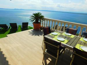 a table on a balcony with a view of the ocean at GMID IMMO A228 Casa Unica in Roses