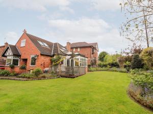 a brick house with a large yard at Dragon's Den in Chester