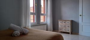 a bedroom with a bed and a large window at CHALET Cubo de las Monjas in Nava del Rey +27 photos