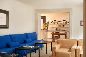 a living room with a blue couch and chairs at Portella Palma in Palma de Mallorca