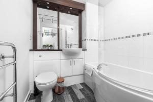a white bathroom with a sink and a toilet at City Centre Apartment 2 Bedroom Secure Parking 201M in Birmingham