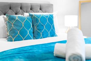 - une chambre avec un lit et des oreillers bleus dans l'établissement City Centre Apartment 2 Bedroom Secure Parking 201M, à Birmingham