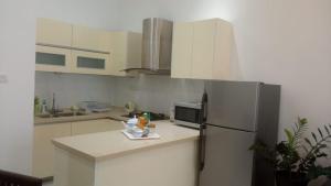 a kitchen with a refrigerator and a counter top at In the heart of Colombo 2 Bedrooms Apartment in Colombo