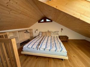 1 dormitorio con 1 cama grande en el ático en Majagatt Holiday Home, en Roveredo