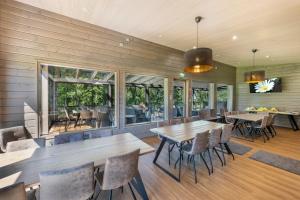 a dining room with wooden tables and chairs at Spa Hotel Runni Iisalmi in Iisalmi