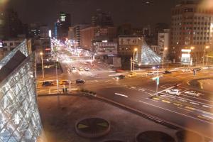 a busy city street at night with cars and lights at Trip GG Hostel in Kaohsiung
