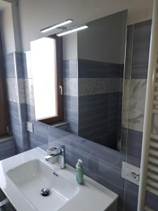 a bathroom with a sink and a mirror at Cappuccini Guest House in San Giovanni in Fiore