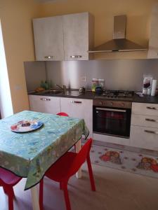 a kitchen with a table and chairs and a stove at Cappuccini Guest House in San Giovanni in Fiore