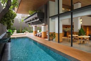 a swimming pool in the middle of a house at ARTOTEL Casa Kuningan in Jakarta