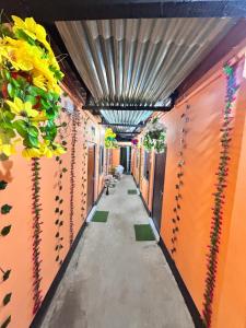 a hallway with flowers on the walls of a building at Sweet Home Lodge in Guwahati