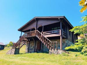 an old cabin on a hill with a wooden staircase at Birun Kumbet Dag Evi in Kumbet