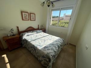 a bedroom with a bed and a window at Villa Ca Bonet (Duende) in Les tres Cales