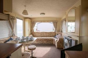 a living room with a couch and a table at Skegness Caravans in Skegness
