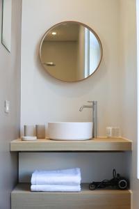 a bathroom with a sink and a mirror at Residence9Bruges in Bruges