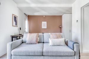 a living room with a blue couch in a room at Renovated La Dreta de lEixample 1br w balcony BCN-89 in Barcelona