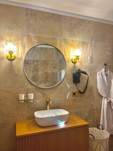 a bathroom with a sink and a mirror at Domaine Victoria in SantʼAntonino